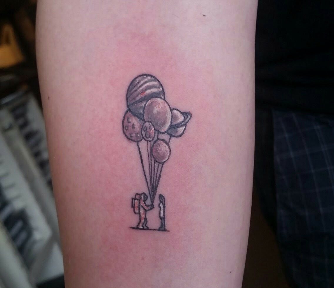 Fine line black and grey astronaut with balloons tattoo