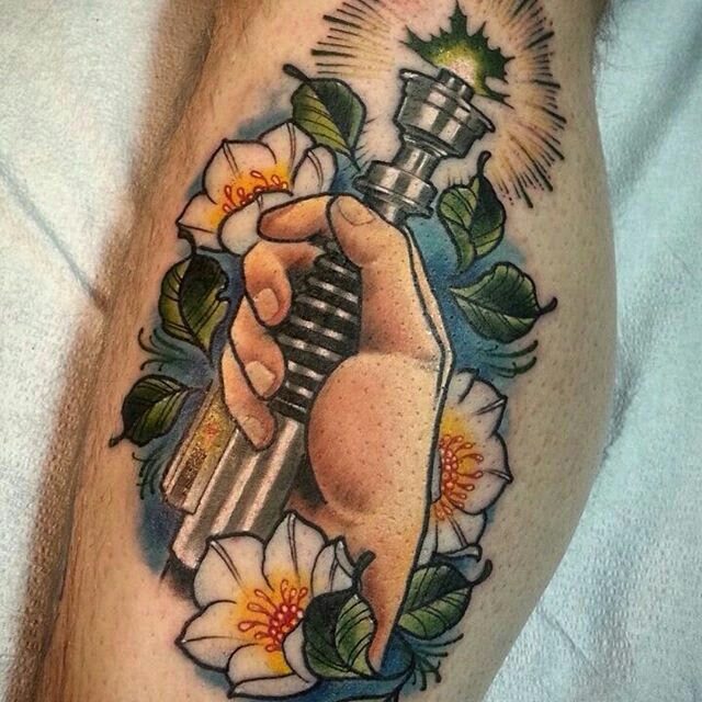 Neo-traditional colour tattoo of a lightsaber and flowers, forearm