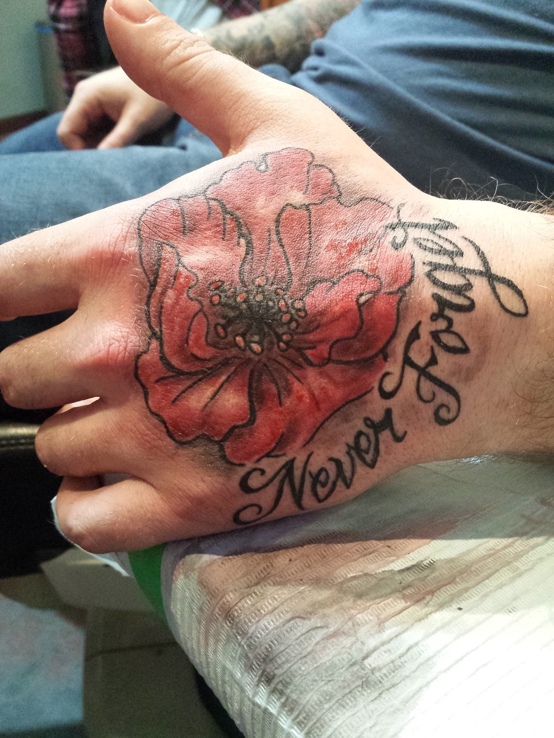Colour red poppy hand tattoo